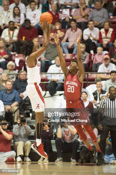 Herbert Jones of the Alabama Crimson Tide takes a shot over Kameron McGusty of the Oklahoma Sooners during the game at Coleman Coliseum on January...