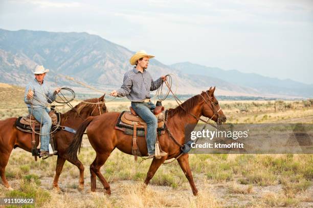 two cowboys warming up for a roping on a utah ranch - boot spur stock pictures, royalty-free photos & images