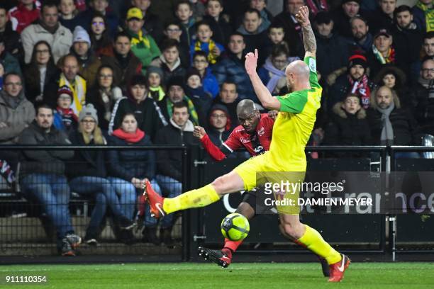 Guingamp's French-Congolese defender Jordan Ikoko does a nutmeg as he kicks the ball between the legs of Nantes' French defender Nicolas Pallois...