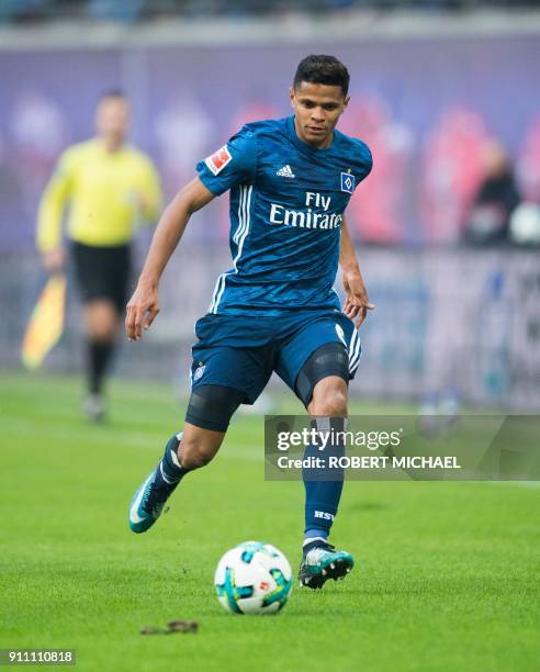 Hamburg´s Brazilian defender Douglas Santos plays the ball during the German first division Bundesliga football match between RB Leipzig and...