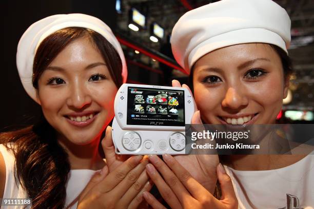 Women hold a PlayStation Portable GO which will be released on November 1 at the Sony Computer Entertainment booth during the Tokyo Game Show 2009...