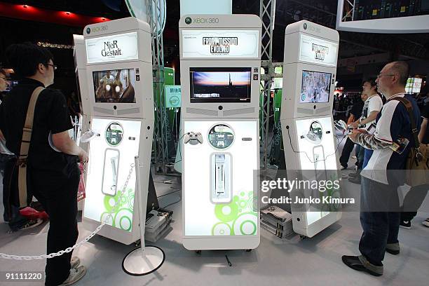 Visitors play with XBOX 360s at the Microsoft booth during the Tokyo Game Show 2009 press and business day at Makuhari Messe on September 24, 2009 in...