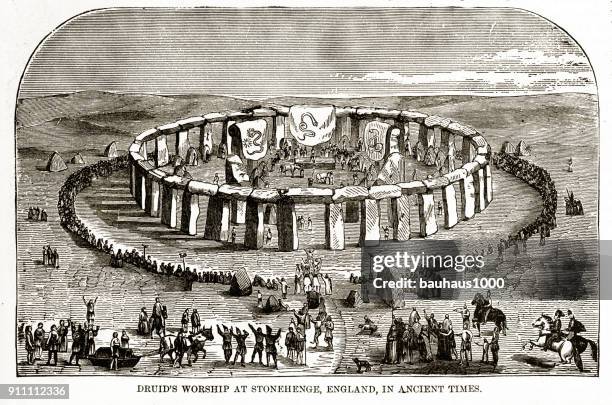 druids worshiping at stonehenge, england in ancient times engraving - paganism stock illustrations