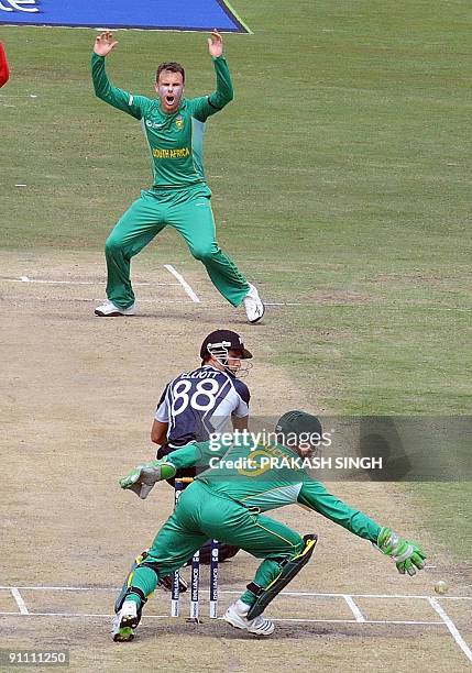 South Africa's Johan Botha reacts as Mark Boucher misses a catch of New Zealand's Grant Elliott during their ICC Champions Trophy group match at...