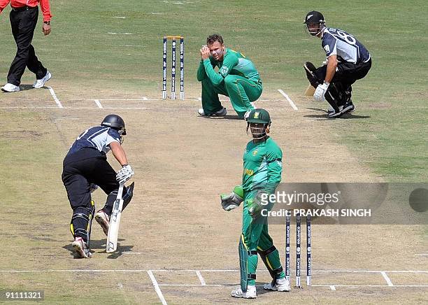 South Africa's Johan Botha reacts after a shot by New Zealand's Ross Taylor as Mark Boucher and Grant Elliott look on during the ICC Champions Trophy...