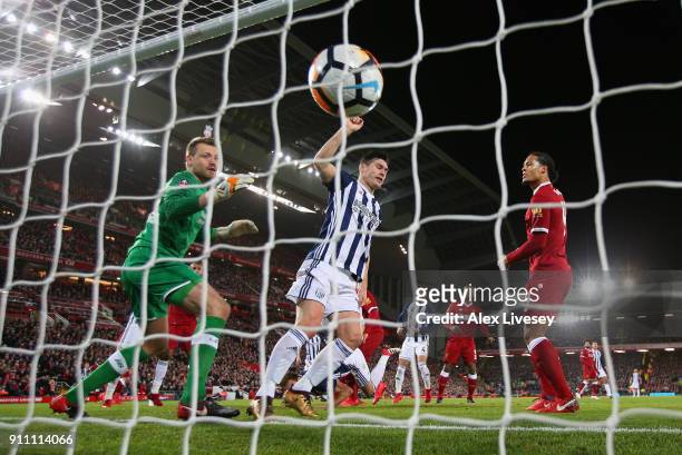 Simon Mignolet of Liverpool and an offside Gareth Barry of West Bromwich Albion watch on as Craig Dawson of West Bromwich Albion scores a goal which...