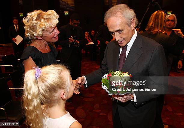 Opera singer Jose Carreras , founder of the Jose Carreras Leukaemia foundation takes flowers as gift from a little girl after the announcement...