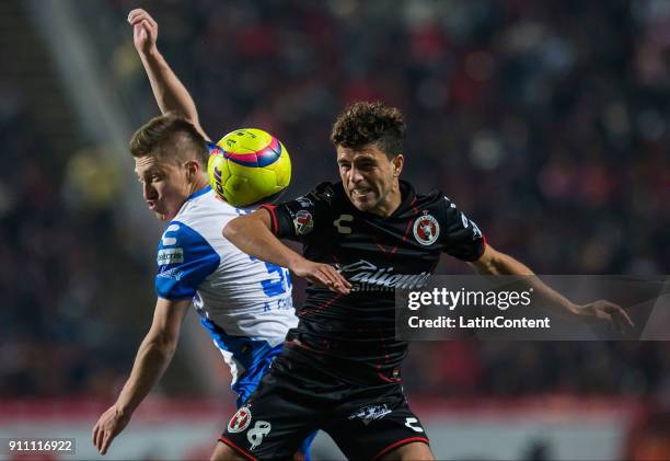 Alejandro Chumacero of Puebla and Ignacio Rivero of Tijuana compete for the ball during the 4th round match between Tijuana and Puebla as part of the...