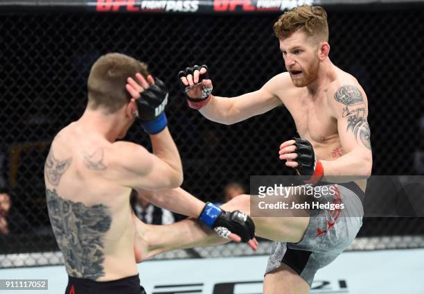 Austin Arnett kicks Cory Sandhagen in their featherweight bout during a UFC Fight Night event at Spectrum Center on January 27, 2018 in Charlotte,...