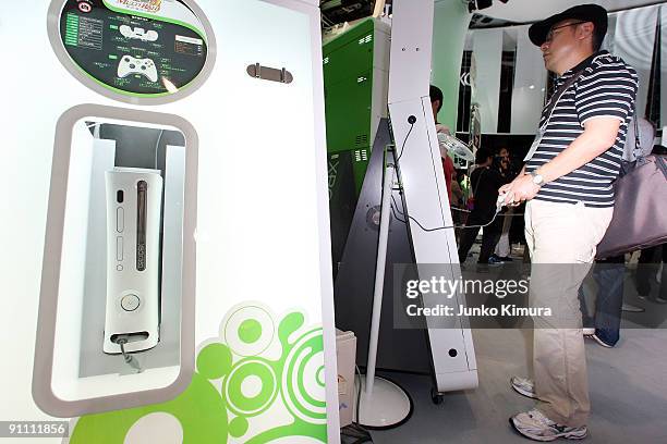 Visitors play with the XBOX 360 at the Microsoft booth during the Tokyo Game Show 2009 press and business day at Makuhari Messe on September 24, 2009...