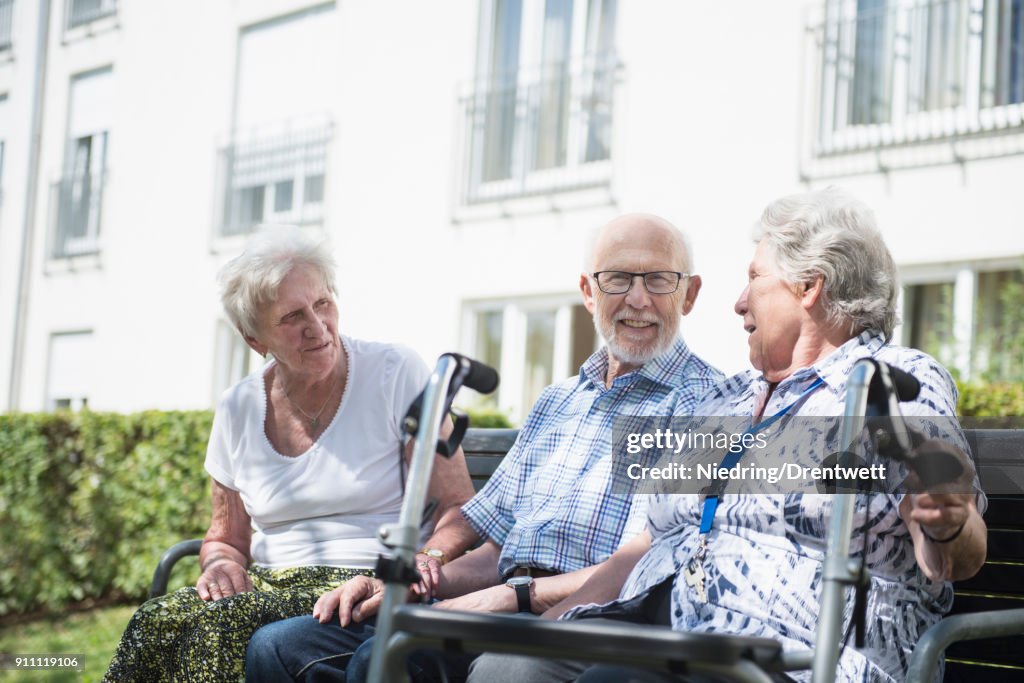 Senior man and women spending time together at garden