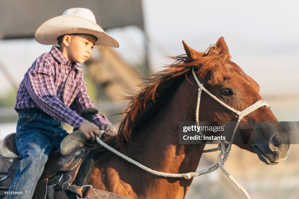 Child Rodeo In A Rodeo Arena Young Child Riding His Horse Before The Action Begins ...
