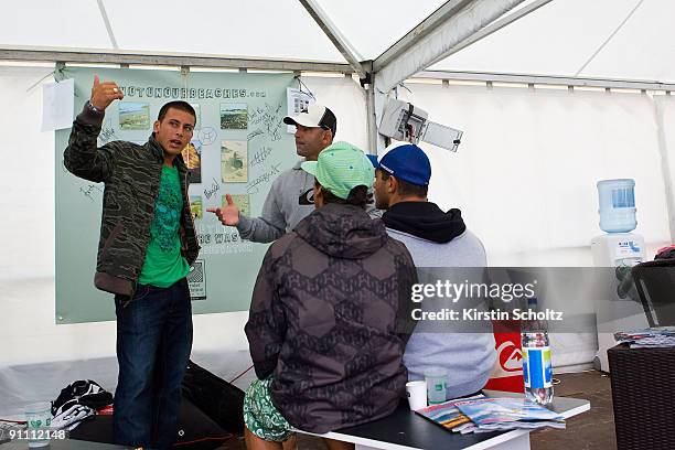 Jeremy Flores of France talks through his round 2 defeat with his coach and managers during the Quiksilver Pro on September 24, 2009 in Hossegor,...