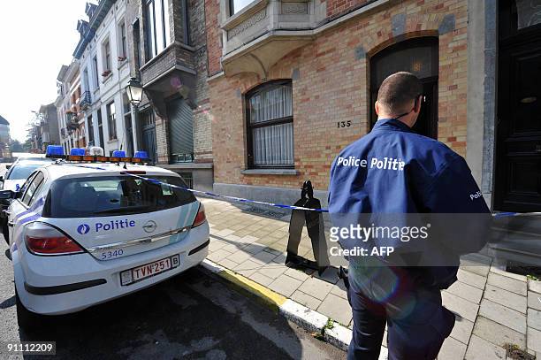 Police officer stands in front of the former house of Belgian surrealist Rene Magritte, which is now a museum, on Esseghem street in Jette, a...