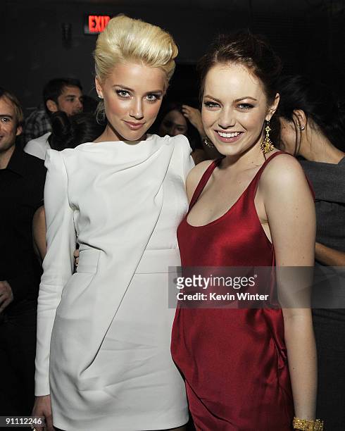 Actors Amber Heard and Emma Stone pose at the after party for the premiere of Sony Pictures' "Zombieland" at h.wood on September 23, 2009 in Los...