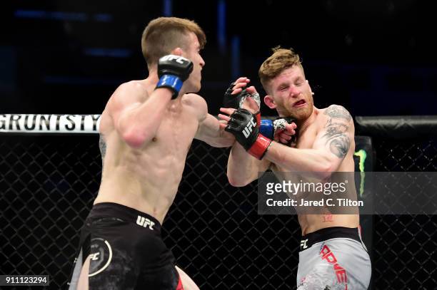 Cory Sandhagen punches Austin Arnett in their welterweight bout during the UFC Fight Night event inside the Spectrum Center on January 27, 2018 in...