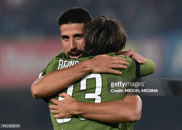 Juventus' German midfielder Sami Khedira is congratulated by Juventus' forward Federico Bernardeschi after scoring during the Italian Serie A...