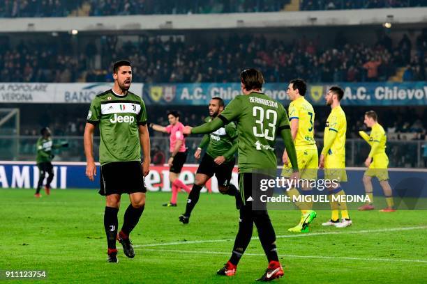 Juventus' German midfielder Sami Khedira is congratulated by Juventus' forward Federico Bernardeschi after scoring during the Italian Serie A...