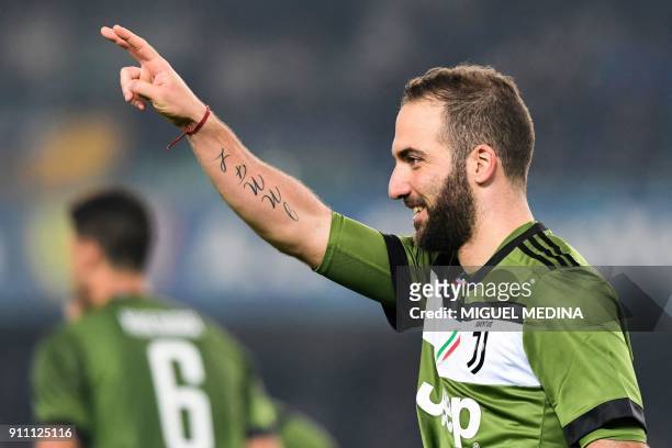 Juventus' Argentinian forward Gonzalo Higuain celebrates after scoring during the Italian Serie A football match AC Chievo vs Juventus at the...