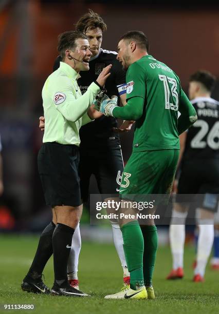 Referee Anthony Backhouse makes a point to Richard O'Donnell of Northampton Town as Ash Taylor looks on during the Sky Bet League One match between...