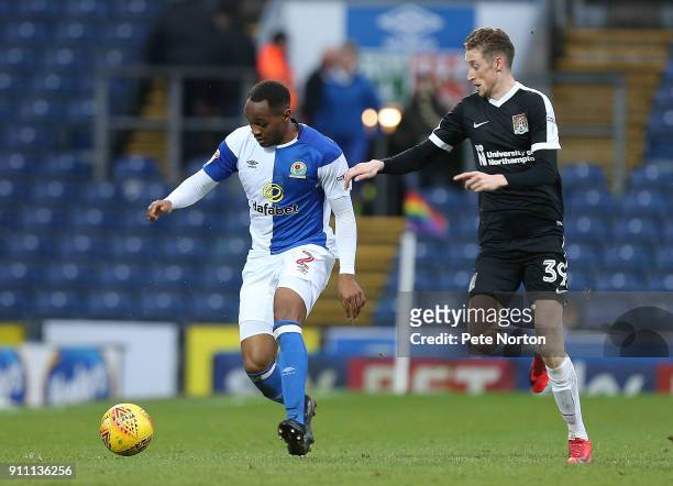 Ryan Nyambe of Blackburn Rovers looks to the ball with Joe Bunney of Northampton Town during the Sky Bet League One match between Blackburn Rovers...