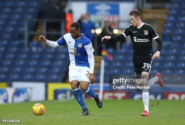 Ryan Nyambe of Blackburn Rovers looks to the ball with Joe Bunney of Northampton Town during the Sky Bet League One match between Blackburn Rovers...