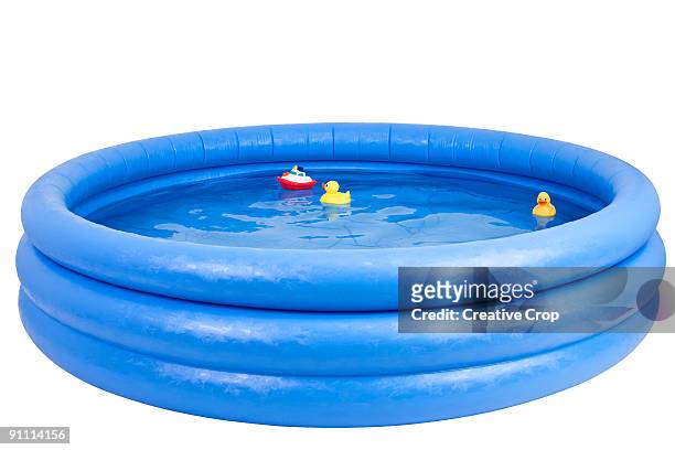 inflatable swimming pool with rubber duck and toy  - planschbecken stock-fotos und bilder