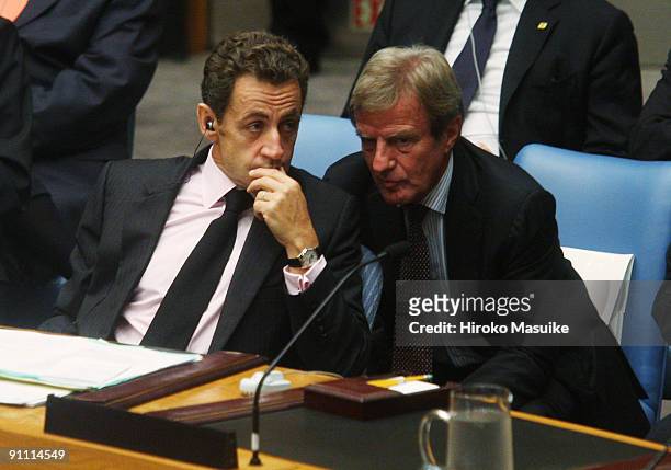 French President Nicolas Sarkozy speaks with French Foreign Minister Bernard Kouchner during a UN Security Council meeting at the United Nations...