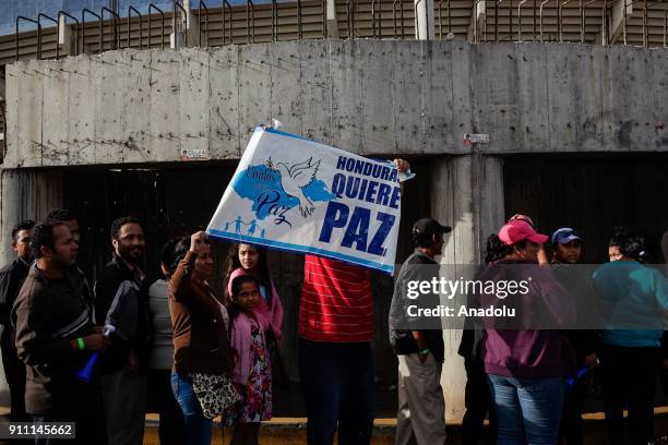 Supporters of newly elected president Juan Orlando Hernandez enter the National of Tegucigalpa for the presidential inauguration ceremony on January...