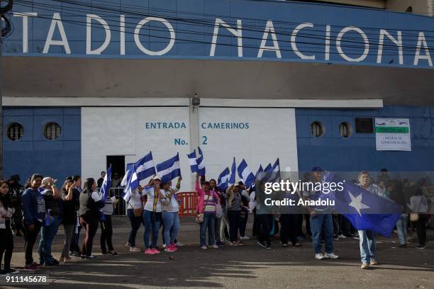 Supporters of newly elected president Juan Orlando Hernandez enter the National of Tegucigalpa for the presidential inauguration ceremony on January...
