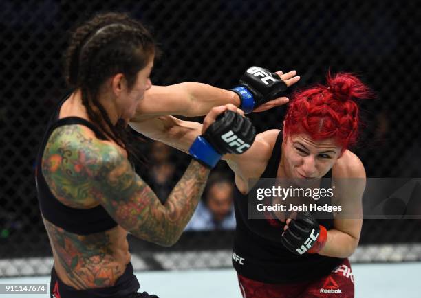 Randa Markos of Iraq punches Juliana Lima of Brazil in their women's strawweight bout during a UFC Fight Night event at Spectrum Center on January...