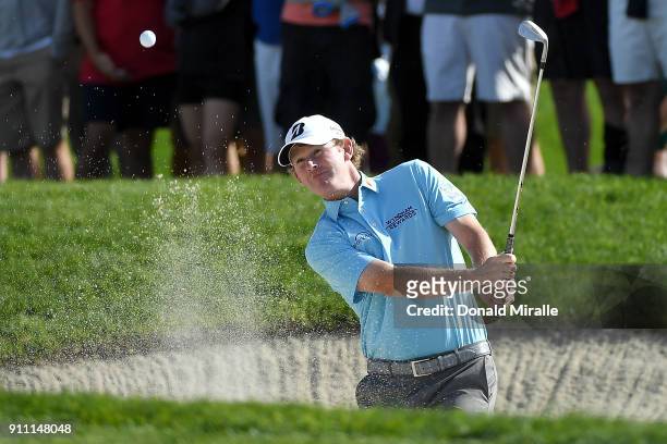 Brandt Snedeker plays a shot from a bunker on the first hole during the third round of the Farmers Insurance Open at Torrey Pines South on January...