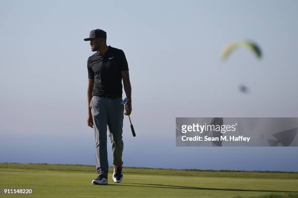 Tony Finau looks over his putt on the 14th green during the third round of the Farmers Insurance Open at Torrey Pines South on January 27, 2018 in...
