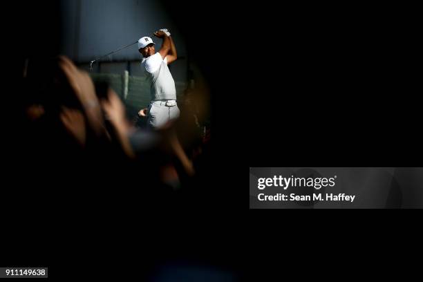 Tiger Woods plays a shot on the tenth hole during the third round of the Farmers Insurance Open at Torrey Pines South on January 27, 2018 in San...