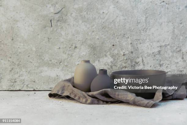 home decor - various neutral colored vases on rough distressed wooden shelf against grey wall. - still life not people stock pictures, royalty-free photos & images