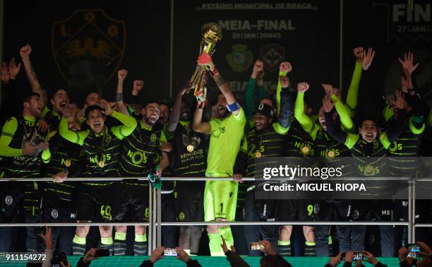 Sporting's Portuguese goalkeeper Rui Patricio holds the trophy as he celebrates with teammates after winning the Portuguese Cup final football match...