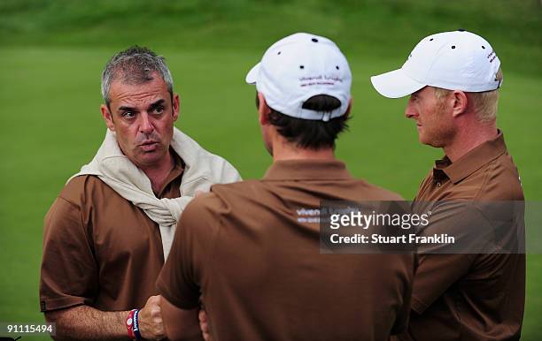 Paul McGinley, Captain of the Great Britian and Northern Ireland team talks with Simon Dyson and Oliver Wilson of the Great Britian and Northern...