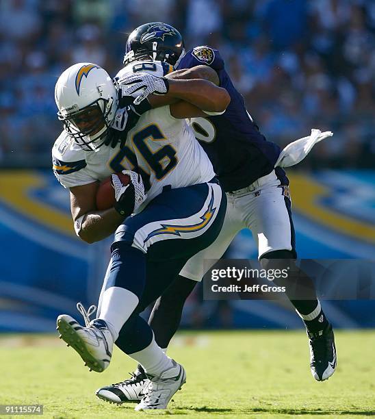 Brandon Manumaleuna of the San Diego Chargers is tackled by Dawan Landry of the Baltimore Ravens at Qualcomm Stadium on September 20, 2009 in San...