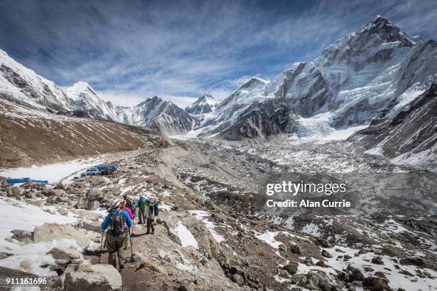 wanderer genießen die sonnige aussicht in der nähe von mount everest base camp, nepal - mt everest base camp stock-fotos und bilder