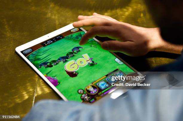 Dancer Valentin Chmerkovskiy plays the video game before a news conference celebrating the 1st Anniversary of One Piece Thousand Storm at the...