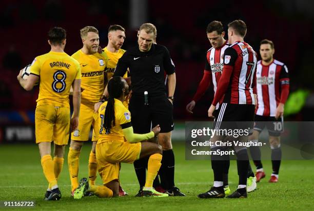 Preston North End's Daniel Johnson speaks to Referee Graham Scott before being shown a yellow card for a foul on Sheffield United's John Fleck during...