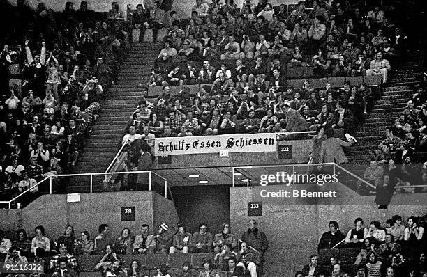 General view of fans sitting behind a sign that reads "Schultz Essen Schiessen" during the Philadelphia Flyers and New York Islanders game at the...