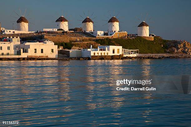 five windmills on hillside relfection in morning  - relfection stock pictures, royalty-free photos & images