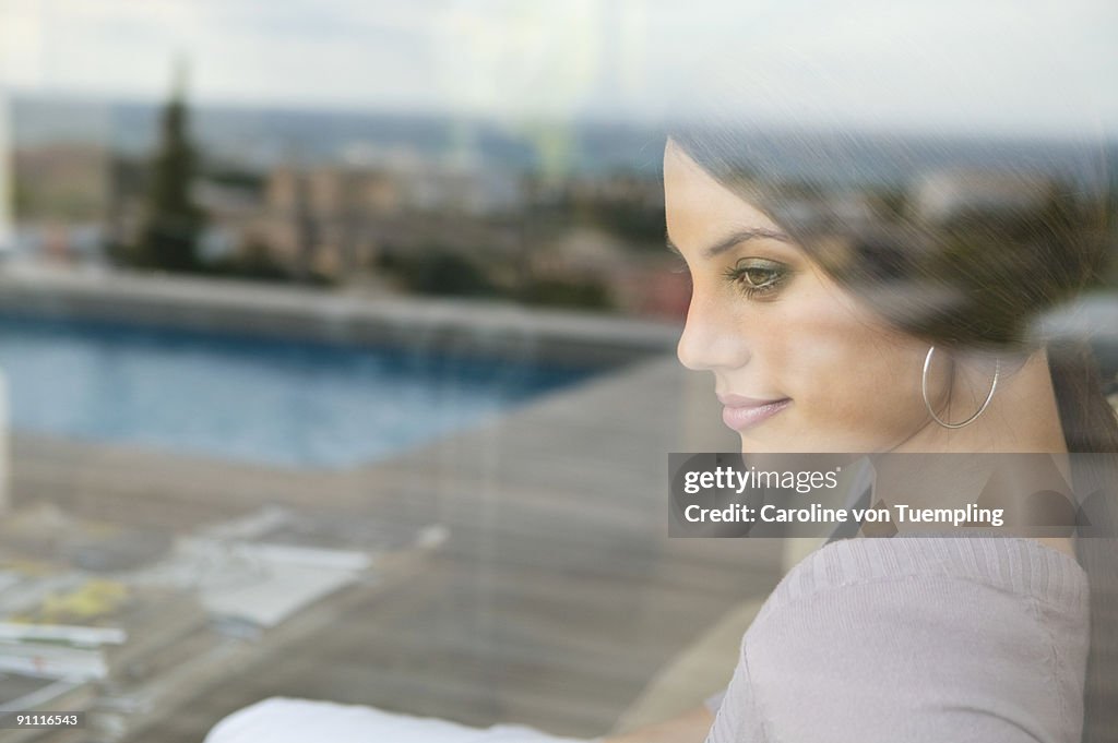 Portrait of woman with reflection of urbanscape