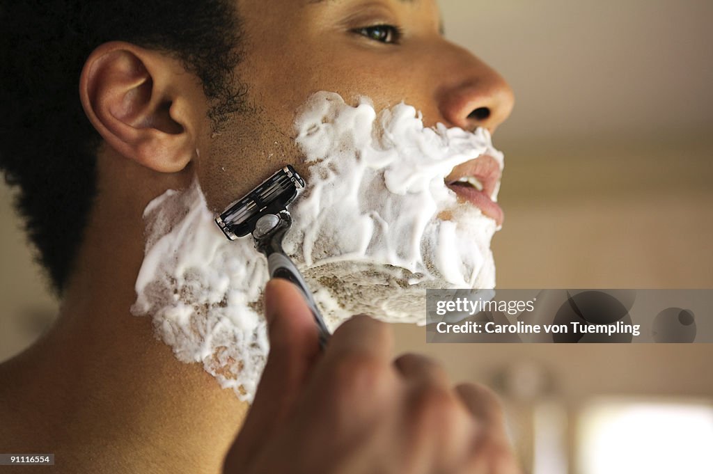 Ethnic man shaving