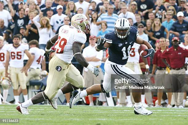 Parker Mangum of Brigham Young University Cougars runs the football against Kendall Smith of Florida State Seminoles at La Vell Edwards Stadium on...