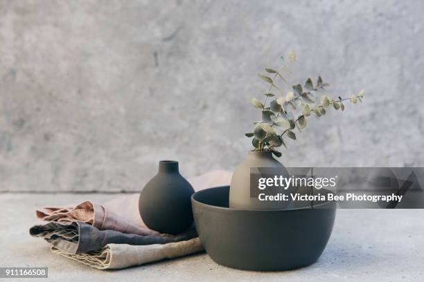 home decor - neutral coloured vases and dish-ware and linen napkin in nordic style against grey wall. - domestic life imagens e fotografias de stock