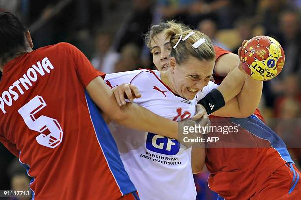 Danish Kristina Bille is stopped by the Russian defence in the womens handball Group A match on September 24 2009 at the GF World Cup tournament in...