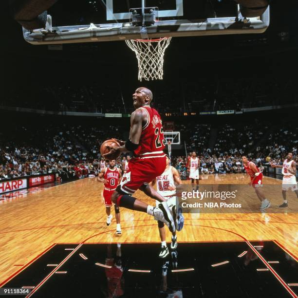Michael Jordan of the Chicago Bulls dunks against the Miami Heat during a game played in 1996 at Miami Arena in Miami, Florida. NOTE TO USER: User...