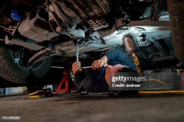 mechanic fixing a car at an auto repair shop - adjusting stock pictures, royalty-free photos & images